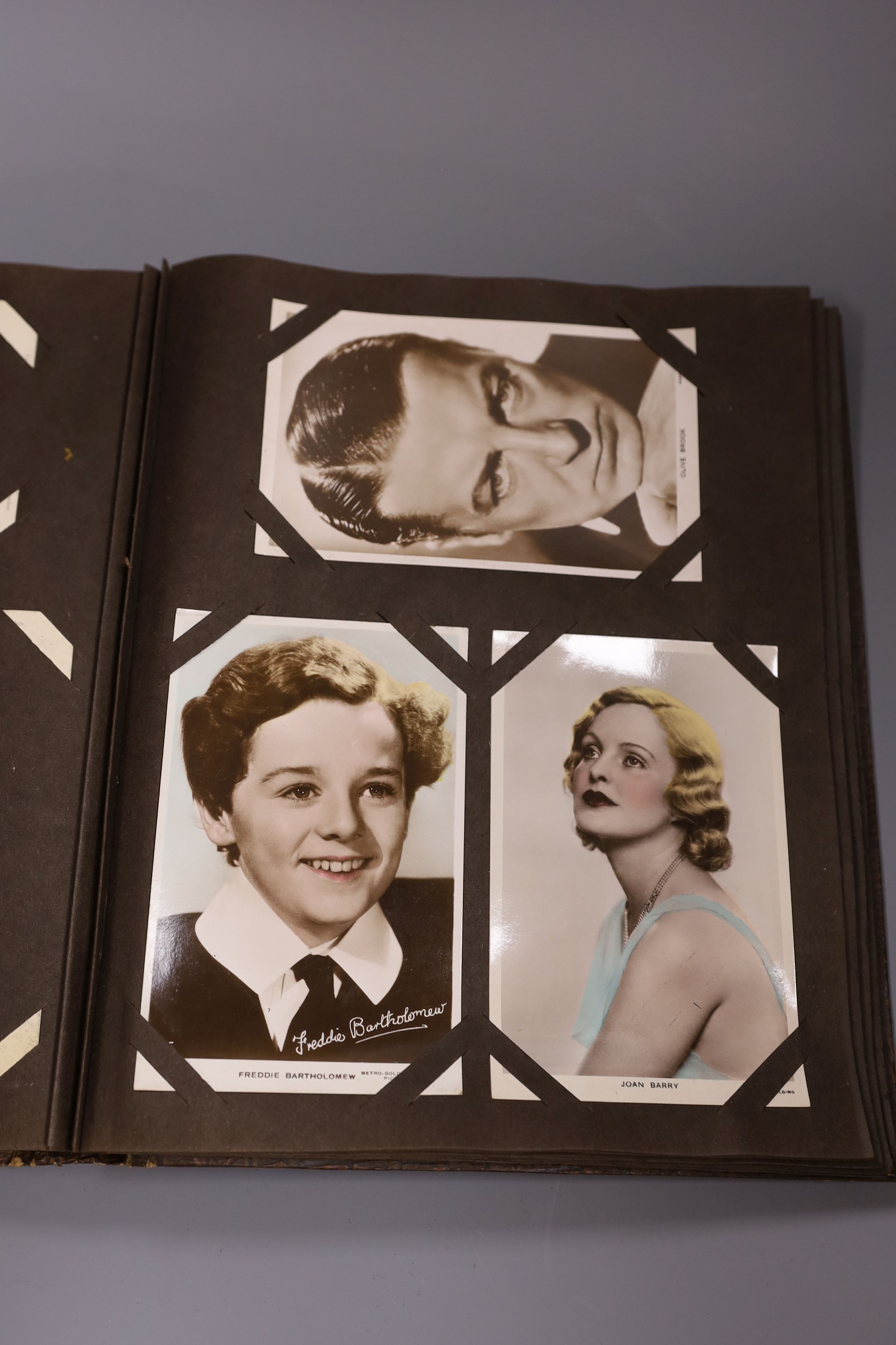 An album of approximately 160 early 20th century monochrome studio postcards including Garbo, Crosby, Gable and Hepburn.